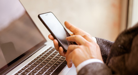 Man pointing on smartphone screen. Close up of male hands with mobile
