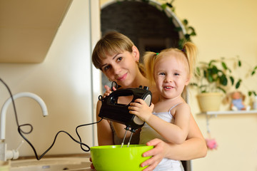 Mom and girl cook a pie together