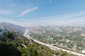 Fototapeta na wymiar Los Angeles view of the highway from a mountain at sunset, clear blue skies