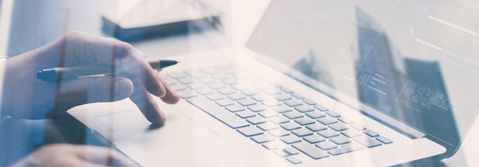 Close-up photo of male hands with laptop. Man is working remotely at home. Distance job