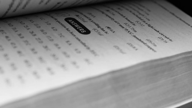 4K flipping book pages close up. Looking through a book turning the pages and reading - Business and education concept