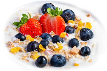 Yogurt with granola, strawberries and blueberries.