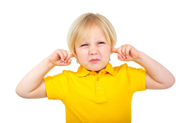 Annoyed boy covers his ears with fingers