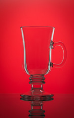 
Glass cup on a red background