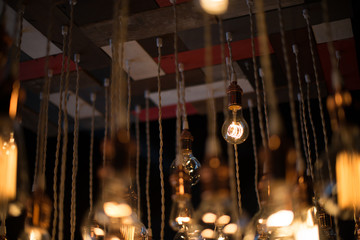 Hanging array of many incandescent light bulbs