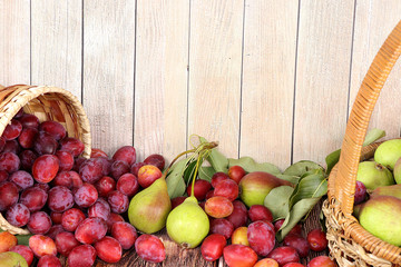 Pear and plum on a sunny table, summer banner, concept of healthy and natural food, diet detox, slimming, top view, flat lay, selective focus, source of vitamins, place for text