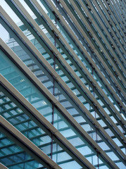 a full frame modern office architecture abstract with geometric shapes and buildings reflected in blue glass windows