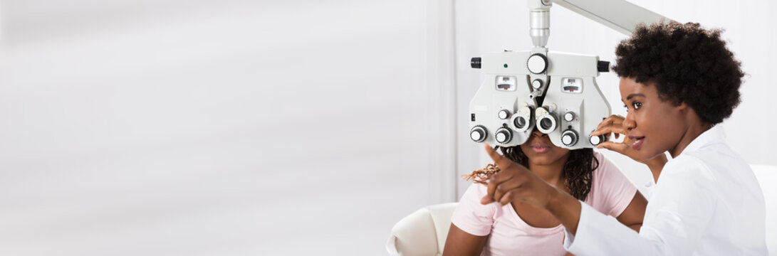 Optometrist Doing Sight Testing For Patient