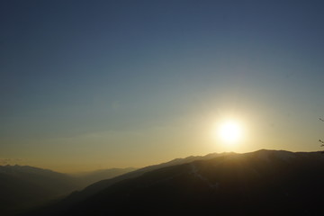 Sonne steht knapp über den Bergen