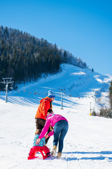 Happy Family In Snow Riding On Sledge.