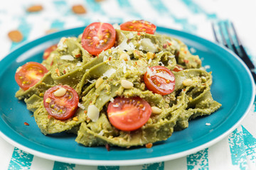 Pasta with pesto, avocado and tomatoes