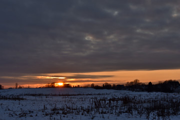 colorful sunset over a snow-covered field