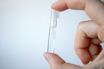 Hand holding perfume vial