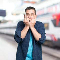 Young man wearing a blue outfit. Looking scared.