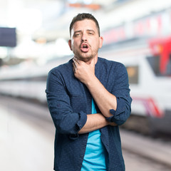 Young man wearing a blue outfit. Got throat.