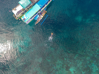 Aerial snorkling near Boat in pink beach