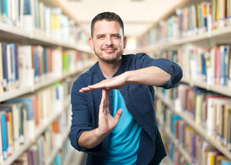 Young man wearing a blue outfit. Doing break time gesture.