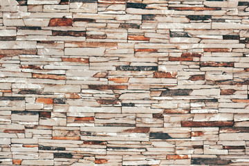 Close view of stone cladding on an outer building wall. 