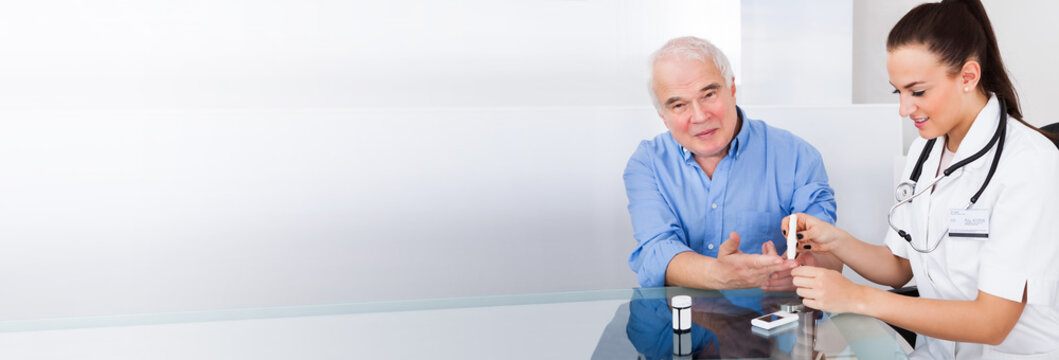 Doctor Using Lancelet On Senior Man