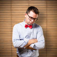 Man wearing a red bow tie. Looking tired.