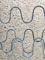 
wire against the background of a wall with stone chips, exterior, decoration, background, industrial