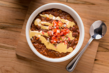 Vegetable Chili with pico de gallo and spoon on the side