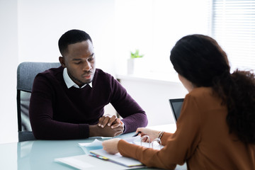 Financial Advisor Discussing Invoice With Her Client