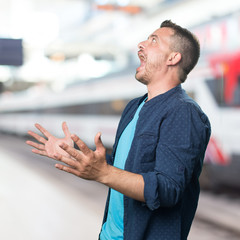 Young man wearing a blue outfit. Looking scared.