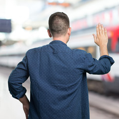 Young man wearing a blue outfit. Doing stop gesture.