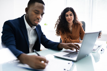 Two Businesspeople Calculating Invoice