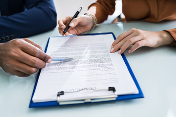 Two Businesspeople Analyzing Document