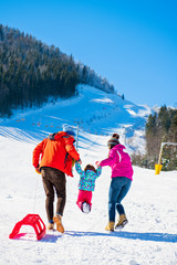 Happy Family In Snow Riding On Sledge.