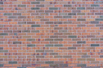 red brick wall background with different colored bricks