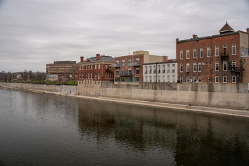 Old historic buildings on the river with calm waters and reflection 