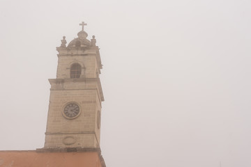 Old church tower in a foggy day at Real del Monte Hidalgo
