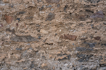 Stone Wall Texture Background with asymmetrical stones stacked together to form a vintage wall