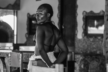 Ghana woman with happy look after a day at the beach in Axim Ghana West Africa. Photo in black and...