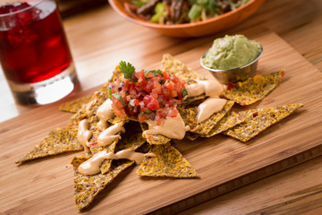 Raw Nachos with pico de gallo vegan cheese and guacamole