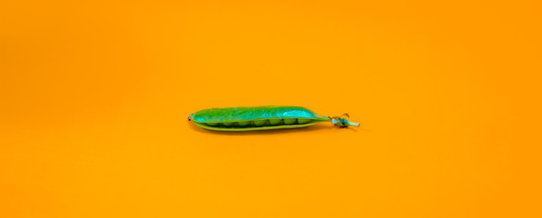 green peas extracted on yellow background