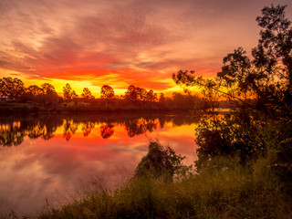 Obraz na płótnie Canvas Colourful River Sunset with Reflections