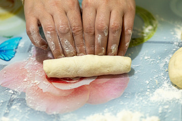 woman makes dough for making bread at home