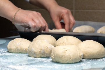 woman makes dough for making bread at home