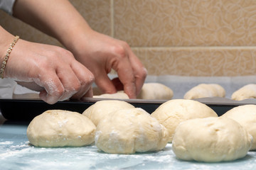 woman makes dough for making bread at home