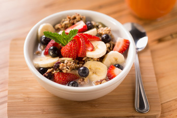 Granola with fresh strawberries, blueberries, and bananas