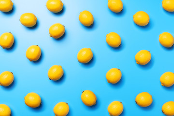 Top view of lemon pattern on a blue background, flat lay for a graphic designer or décor concept