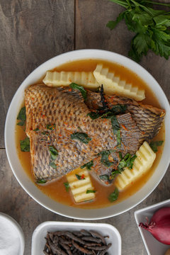 Grilled fish curry with plantain and salad. African national dish. Nigerian fish curry. Healthy lifestyle meal. Vegetarian food