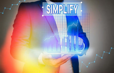 Conceptual hand writing showing Simplify. Concept meaning make something simpler or easier to do or...