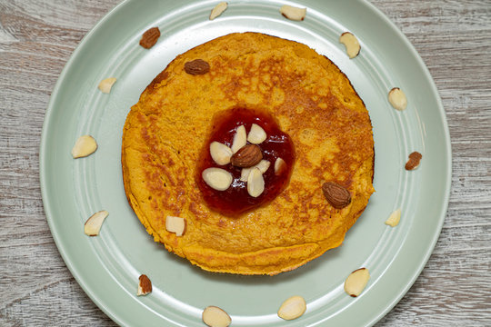 Sweet Potato Pancake Topped With Strawberry Jam And Almond Slices