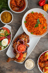 Grilled chicken with red onions. African food meal. Nigerian national dish. Fresh and healthy with tomatoes and red onions. Fried food. Fresh salad with peppers Cuisine