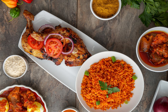 Grilled chicken with red onions. African food meal. Nigerian national dish. Fresh and healthy with tomatoes and red onions. Fried food. Fresh salad with peppers Cuisine